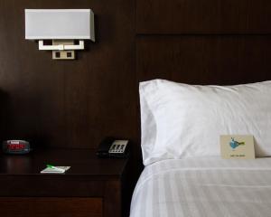 a hotel room with a bed and a phone on a table at Holiday Inn Victorville, an IHG Hotel in Victorville