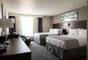 a hotel room with two beds and a large window at Holiday Inn Victorville, an IHG Hotel in Victorville