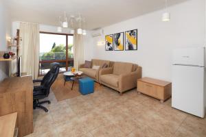 a living room with a couch and a table at Infinity Apartment Nessebar in Nesebar