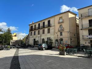 a large building with cars parked in a courtyard at 7 Cannelle Guest House in Isernia