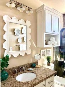 a bathroom with a sink and a mirror at Fun-filled Luxury Beach Vacation Experience - Family Friendly Quiet Cul De Sac! in Bolivar Peninsula +32 photos