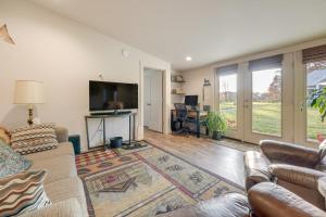 a living room with a couch and a television at Pet-Friendly White Pigeon Apartment with Fire Pit! in White Pigeon