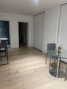 a room with a table and a chair and a room with a hallway at Stunning 2 Bedroom Apartment in London