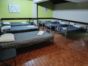 a group of beds in a room at City Drops Hostel Clérigos Private Room in Porto
