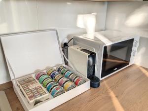 a white box with a microwave next to it at Appartement aux salins du lion in Vitrolles