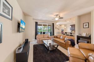a living room with two couches and a tv at Palms Place in Indio in Indio