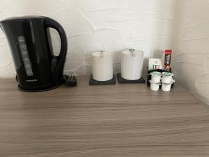 a black coffee pot and candles on a table at River side rooms in Southampton