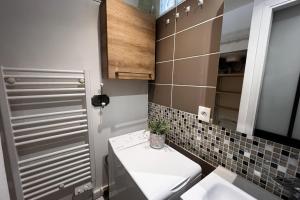 a small bathroom with a toilet and a sink at Cozy love cocoon in the heart of Paris 2nd in Paris