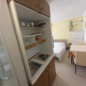 a kitchen with a sink and a stove in it at Apartment & studio Elizabet in Baška