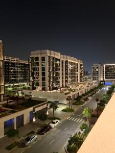 a city street with cars parked in front of buildings at Modern Studio Center of Dubai in Dubai