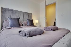 two beds with towels on top of them in a bedroom at 17 Banstead Road in Poole