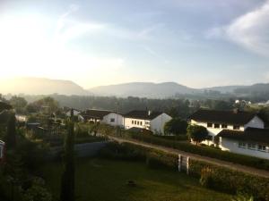 a view of a village with houses and mountains at Swiss View in Hohentengen