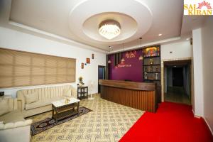 a living room with a couch and a red carpet at Saikiran Hotel in Mapusa
