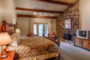 a bedroom with a bed and a stone wall at Fontana Village Resort & Marina in Fontana Village
