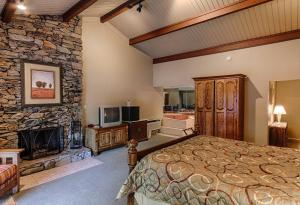 a bedroom with a bed and a stone fireplace at Fontana Village Resort & Marina in Fontana Village +22 photos