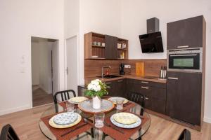 une cuisine avec une table et deux chaises et une cuisine avec dans l'établissement Appartement avec terrasse, à Libourne