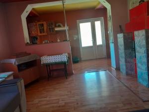 a kitchen with a door and a table in a room at Casă de relaxare in Brad
