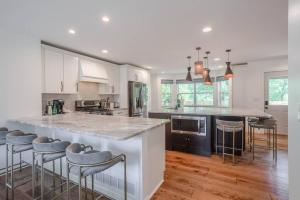 a kitchen with a large island with bar stools at Spacious, Modern 5B in Mason by I-71, Kings Island in Mason