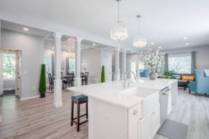 a kitchen and living room with a sink and a counter at Glamorous, Upscale 5B Hyde Park Home with Outdoor Patio in Cincinnati