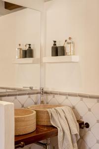 a bathroom with a wooden sink and some towels at Can Noves - Villa de 5 suites 28 y 58 in Sant Francesc Xavier
