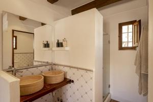 a bathroom with a wooden sink and a mirror at Can Noves - Villa de 5 suites 28 y 58 in Sant Francesc Xavier