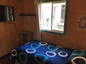 1 dormitorio con 1 cama con edredón azul y blanco en Cabaña 2D-2B Vista única, en Teguaco