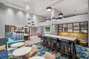 a rendering of a lobby with tables and chairs at Hampton Inn Morro Bay in Morro Bay