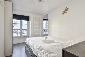 Ein Bett oder Betten in einem Zimmer der Unterkunft Beautiful apartment close to the Eiffel Tower - Welkeys