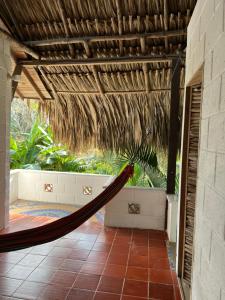 a hammock hanging from a pergola on a patio at AFRO HOSTEL in Necoclí
