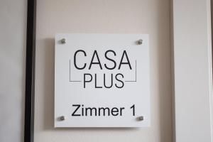 a sign on a wall with the words casa plus zimmer at Casa Plus in Villach