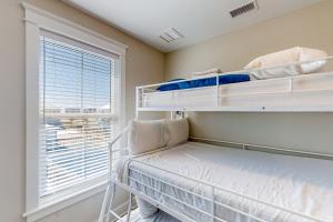 a bedroom with two bunk beds and a window at Home Sweet San Blas in Cape San Blas
