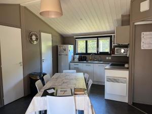 a kitchen with a table and chairs in a room at Le Chalet de la Folie in Corcieux