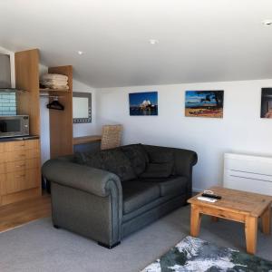 a living room with a couch and a coffee table at Ruby Bay Loft Apartment in Nelson