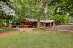 a cabin in the woods with a tree at Cozy Cabin on 1 Acre in Premier Pine Neighborhood in Pine