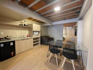 Canela的住宿－Loft 9 entre gramado e canela，厨房以及带桌椅的用餐室。