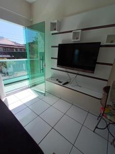 a living room with a flat screen tv on the wall at Residencial Vovó Luiz in Florianópolis