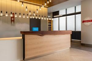 a lobby of a restaurant with a counter and chandeliers at Hampton Inn & Suites San Mateo-San Francisco Airport in San Mateo