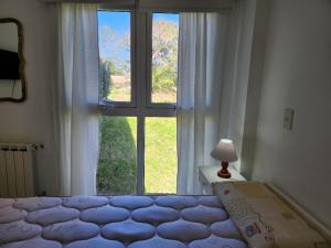 1 dormitorio con 1 cama frente a una ventana en Familiar Pinar Gesell en Villa Gesell