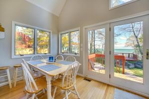 een eetkamer met een tafel, stoelen en ramen bij Lake Huron Vacation Rental with Private Beach! 