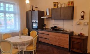a kitchen with a table and chairs and a kitchen with a counter at Historisches Badehaus in Hoym