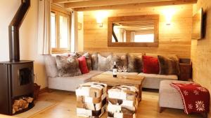 a living room with a couch and a stove at Chalet Mimi in Morzine