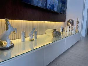 a glass counter with items on top of it at A luxury three-bedroom apartment in the heart of Riyadh in Riyadh