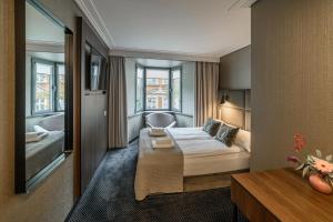 a hotel room with a bed and a window at Hotel Logos Kraków in Krakow