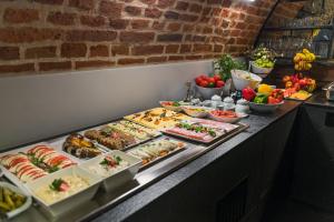 a buffet line with many different types of food at Hotel Logos Kraków in Krakow