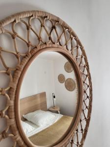 a mirror with a bed in a bedroom at Appartement avec son toit terrasse, en plein coeur de Marseille in Marseille