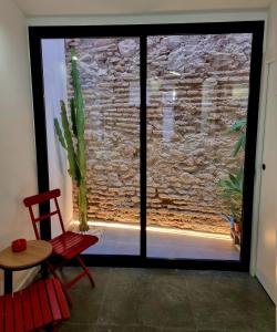 a room with a large window with a cactus at cactus loft Ruzafa in Valencia