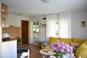 - un salon avec un canapé et une table fleurie dans l'établissement Little Nook, à Čačak