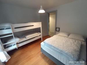 a bedroom with a bed and a bunk bed at A 2 pas du lac in Xonrupt-Longemer