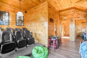 a room with chairs and a bed in a cabin at A Higher Calling, 1089 of FREE area attraction tickets for each paid day, Dollywood and More! in Pigeon Forge