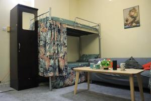 a room with a bunk bed and a table at Al Seef View in Dubai